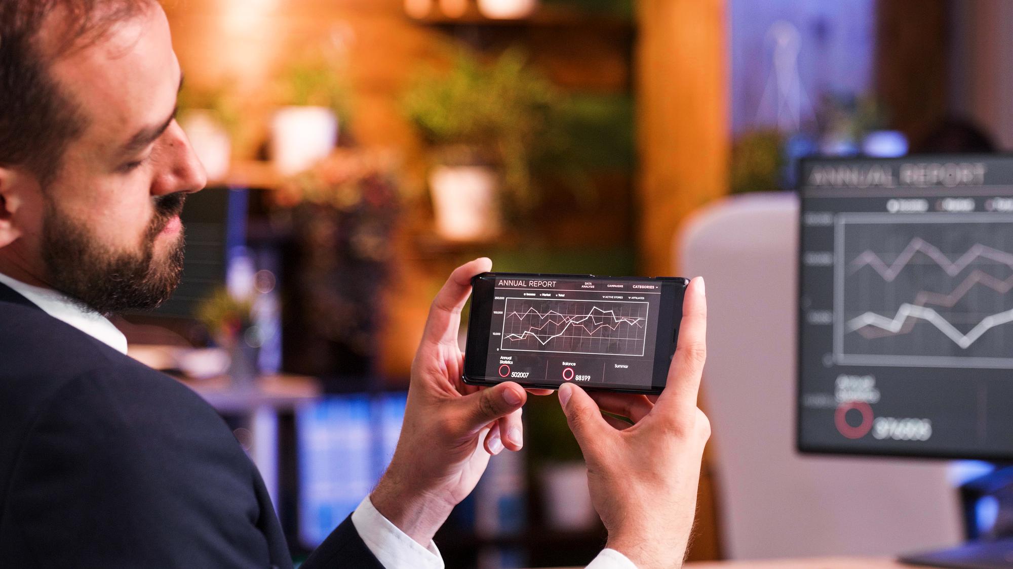 Executive reviewing stock data on tablet